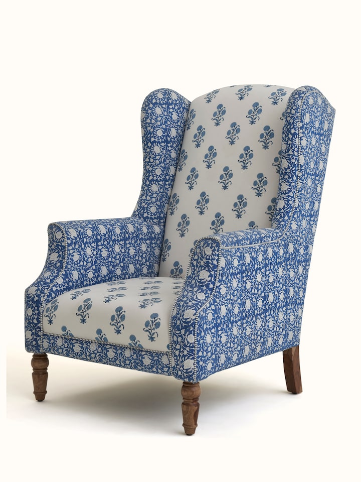 Close-up of the block print detailing on the upholstered Sheesham wood wing chair, emphasizing the craftsmanship and textile pattern