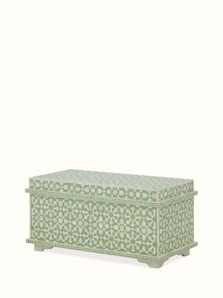 Angled view of the bone inlaid trunk, emphasizing the ornate inlay work and classic design