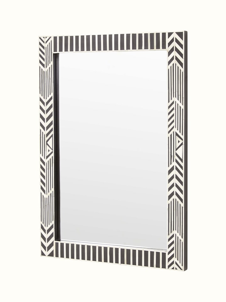 Close-up of the bone inlay on the rectangular wall mirror, showing the fine details and pattern of the inlay work