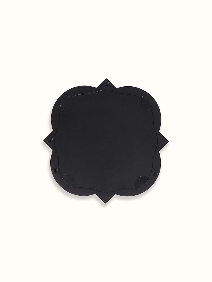 Detailed view of the mirror's frame, showcasing the elegant bone inlay work and the quatrefoil shape