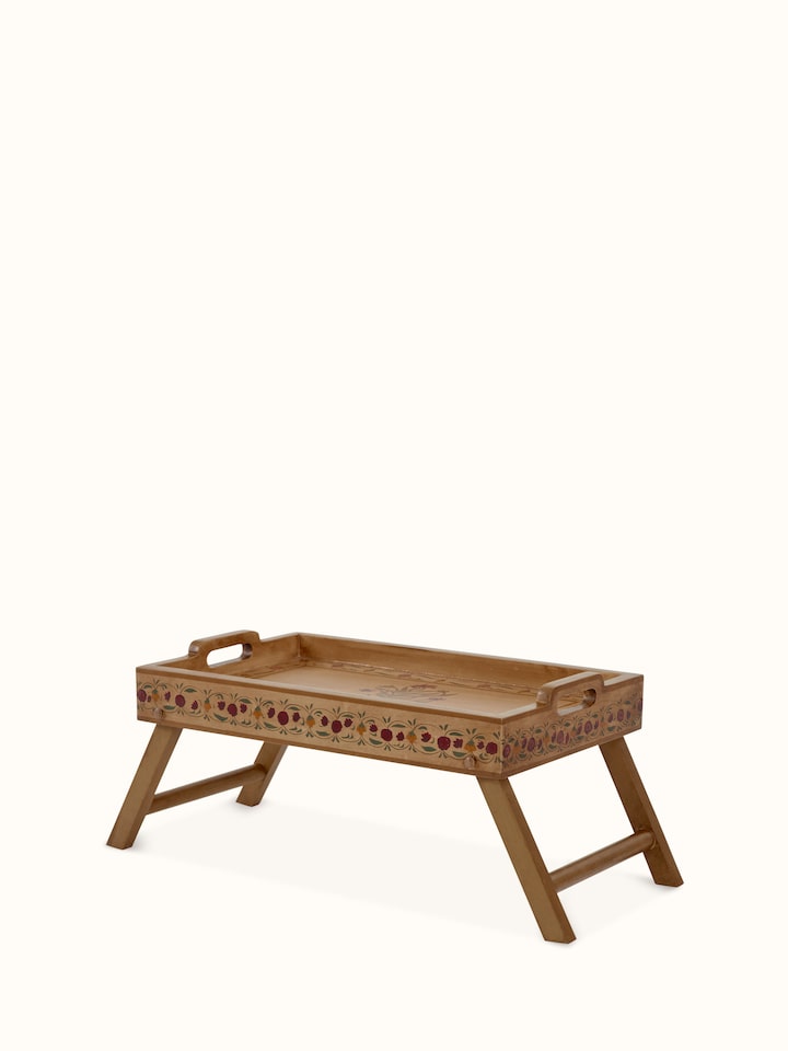Angled view of miniature painted portable table showing the intricate paint details