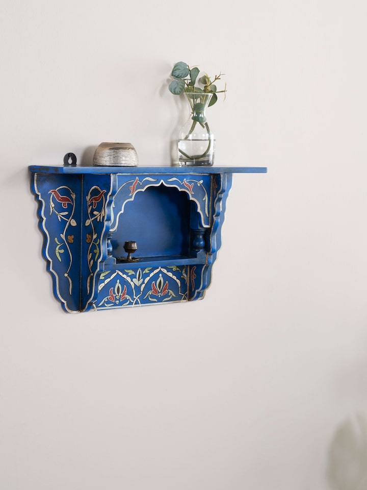 Front view of blue miniature painted wall shelf showing the detailed artwork and decorative elements