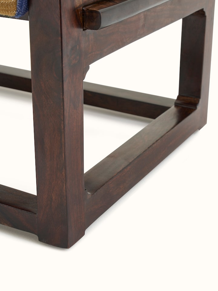 View of the Sheesham wood ottoman in a room setting, demonstrating its versatility and aesthetic appeal in home decor