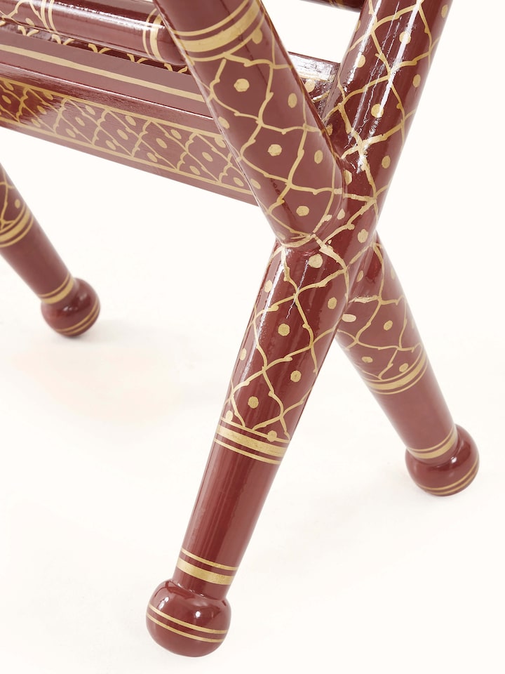 Angle view of Teak Wood Sankheda Cross Leg Magazine Rack, emphasizing the cross-leg design and practical magazine storage