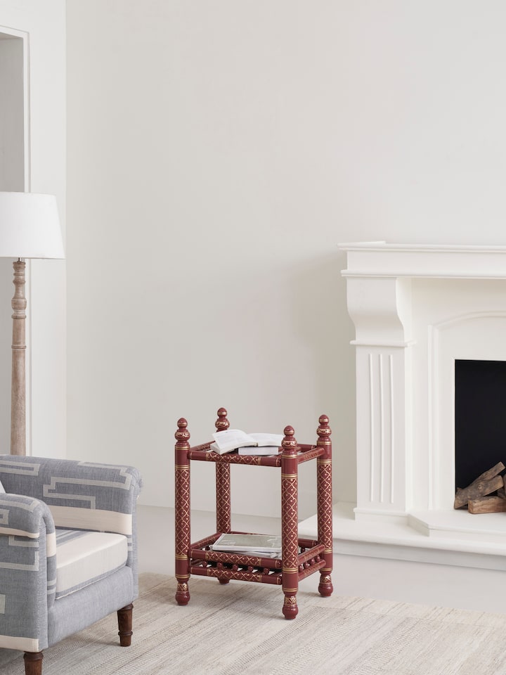 Side view of the teak wood Sankheda magazine rack, highlighting the detailed woodwork and design