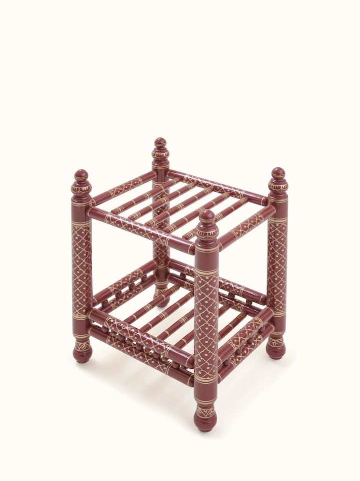 Close-up view of the teak wood Sankheda magazine rack, emphasizing the intricate wood carvings and finish