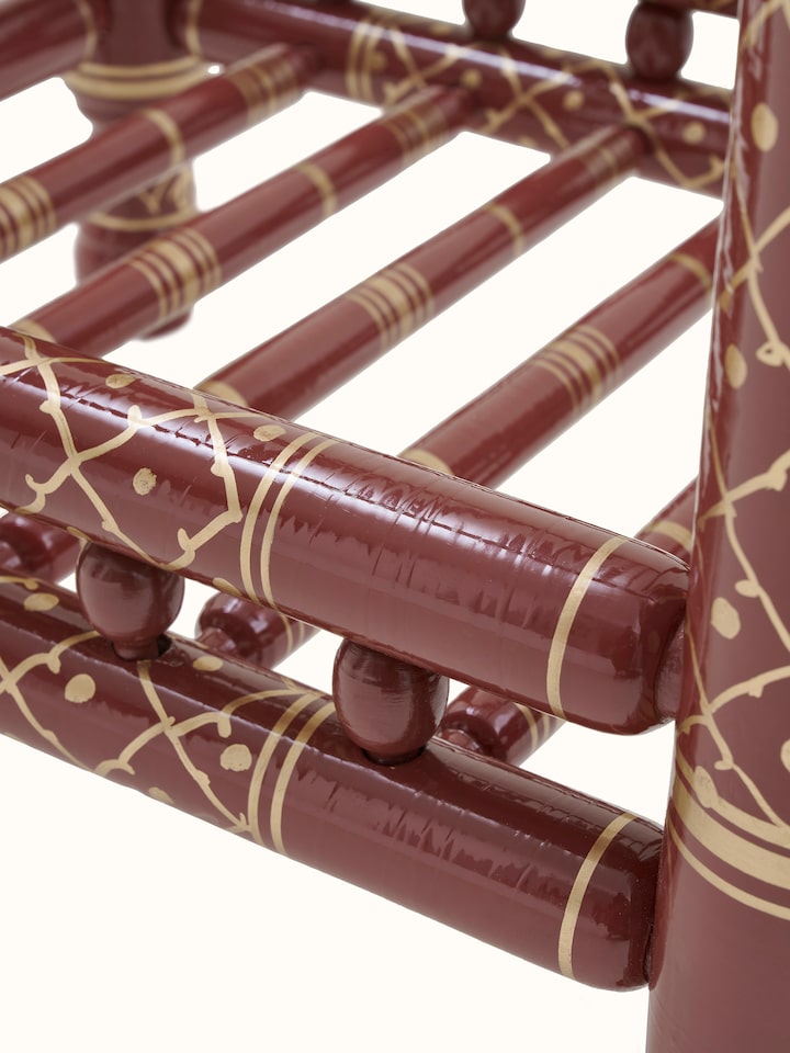 Close-up of the teak wood Sankheda magazine rack, highlighting the natural wood grain and craftsmanship