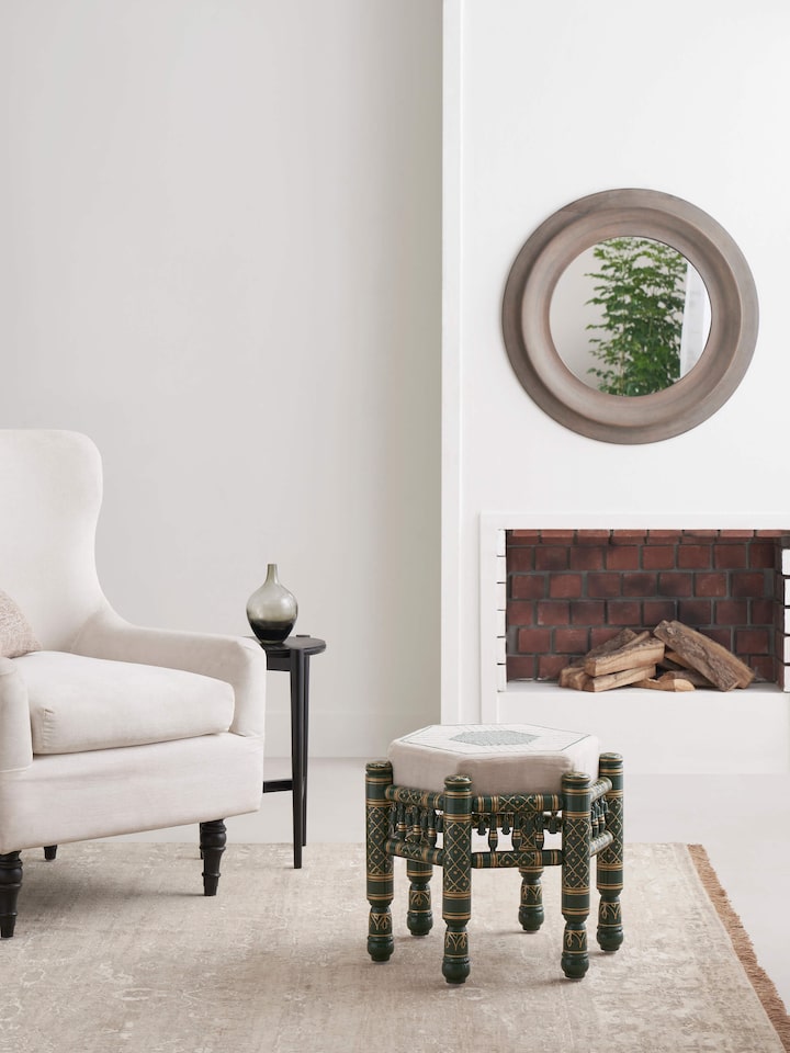 Side view of Upholstered teak wood Sankheda octagonal pouffe highlighting rich upholstery