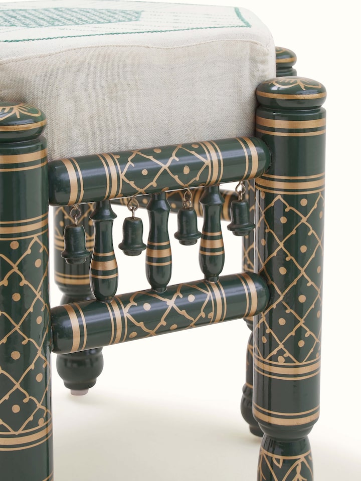 Back view of Upholstered teak wood Sankheda octagonal pouffe highlighting solid construction