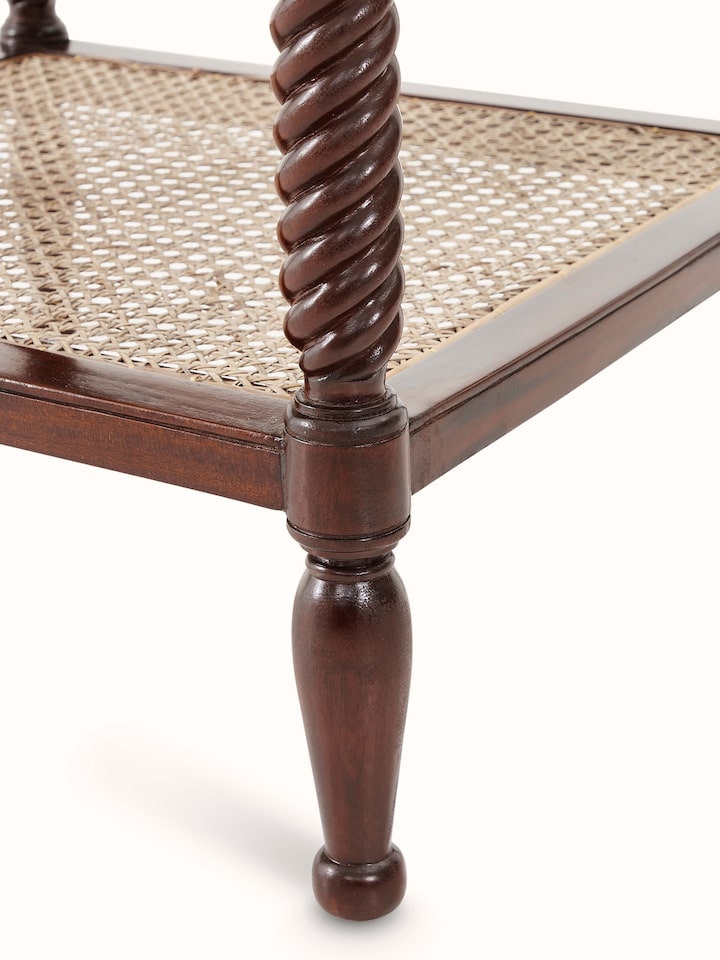 Detailed view of the mahogany wood and cane bedside table's top surface, emphasizing the elegant cane pattern and wood grain.