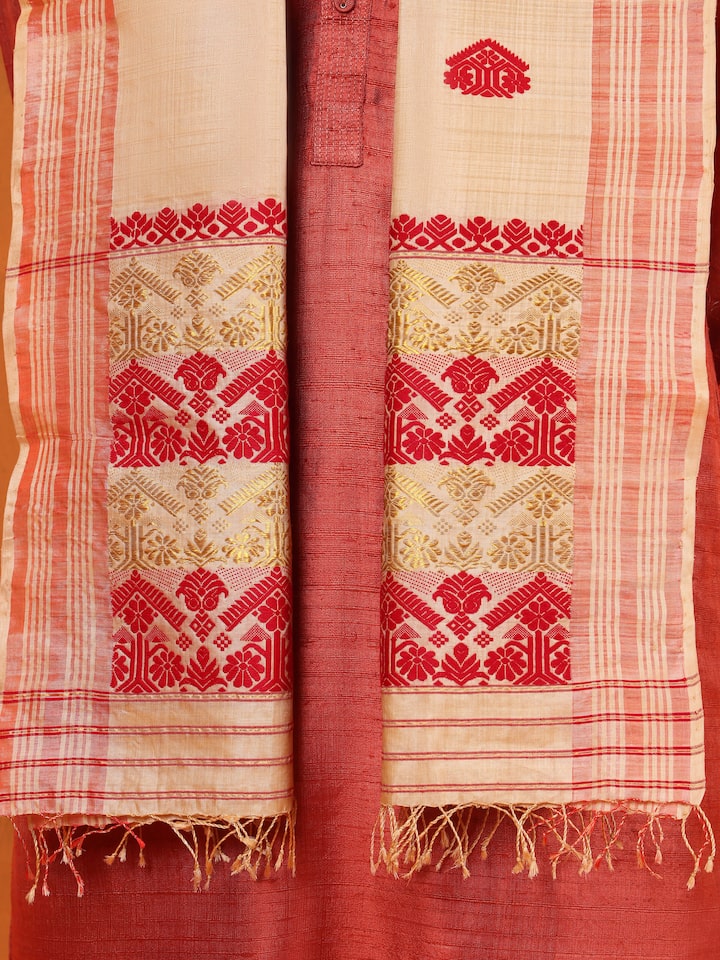 Detail shot of peach tussar silk stole focusing on subtle weave and border