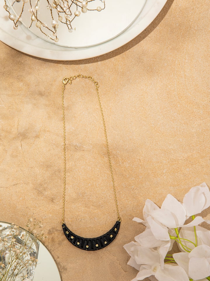 Close-up of raffia fibre long necklace focusing on the texture and detailed craftsmanship of the natural fibres.