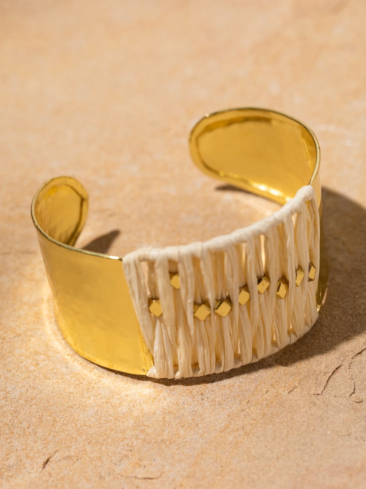 Detailed view of Raffia fibre hand cuff with natural fiber texture.