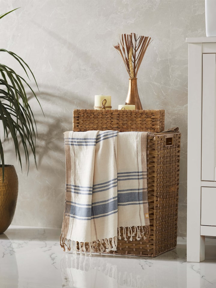 Side view of Sarvika blue checks cotton bath towel (L) emphasizing its checkered design and absorbent fabric.