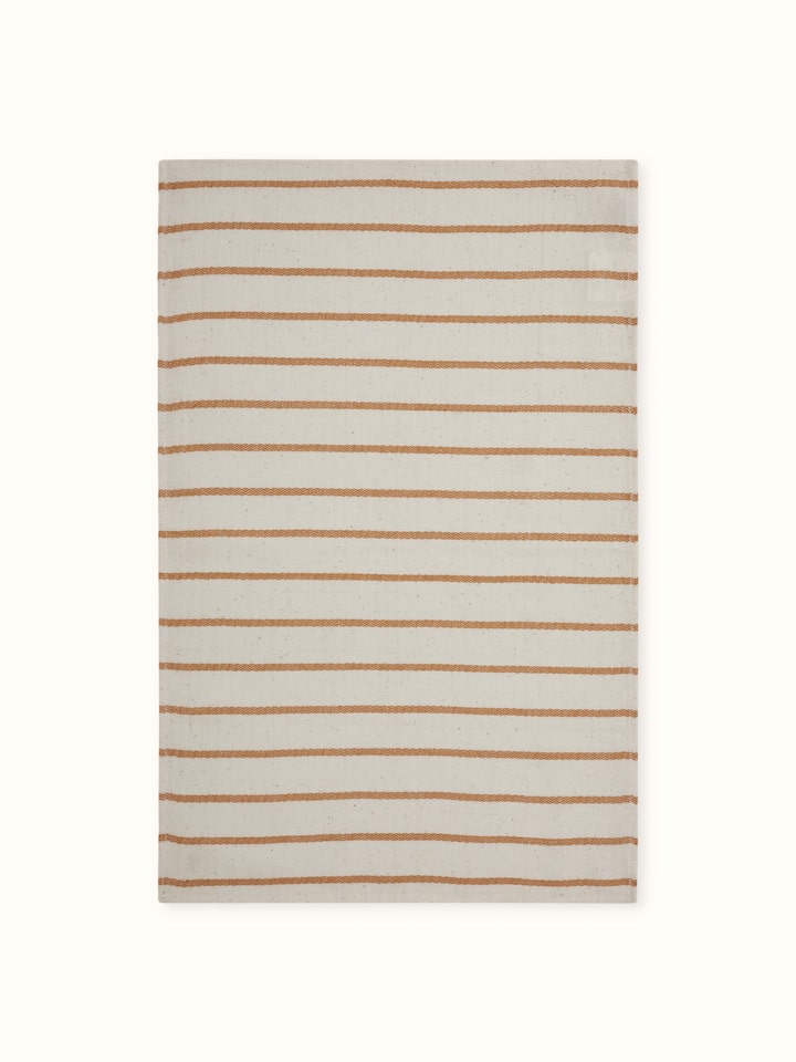 Samitha rust stripe cotton hand towel, focusing on the fabric's soft texture and color.