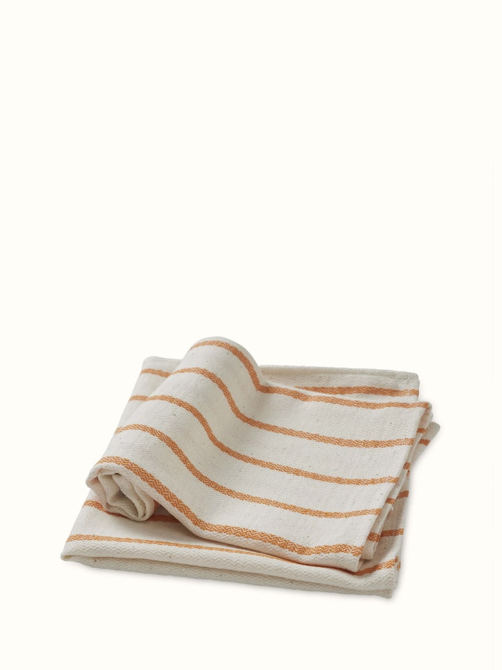 Samitha rust stripe cotton hand towels, showing the stripes and fabric quality in a detailed view.