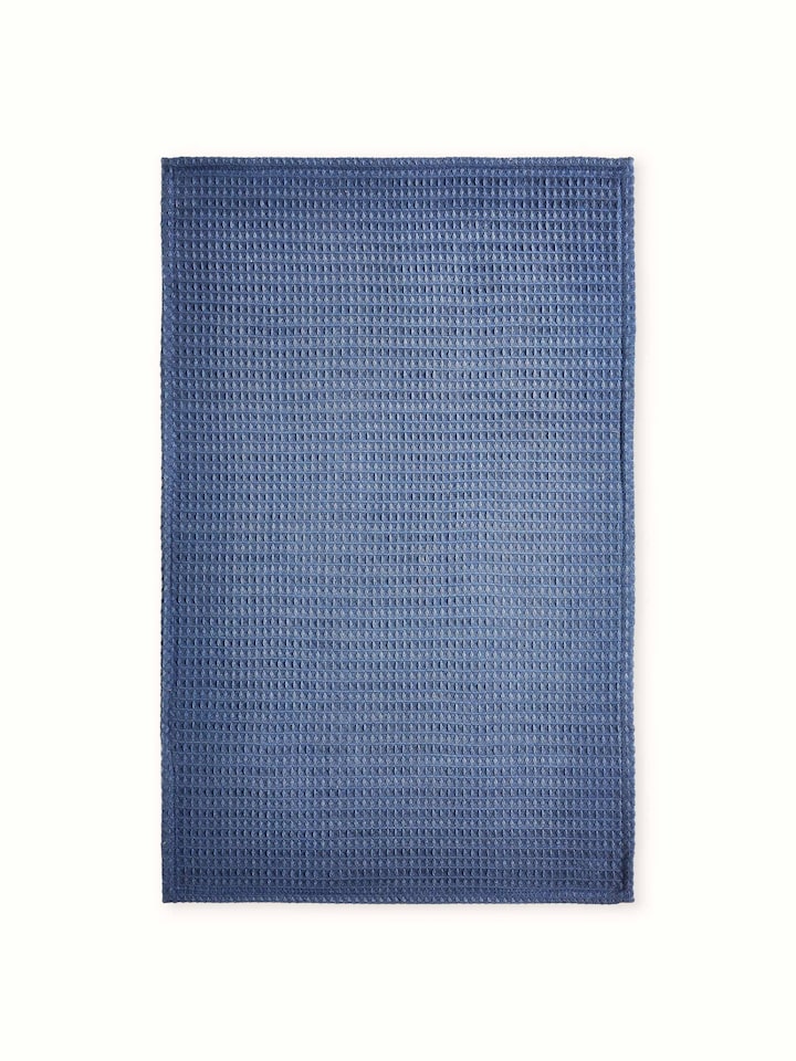 Amala blue waffle cotton hand towels, arranged to show the texture and color in a natural setting.