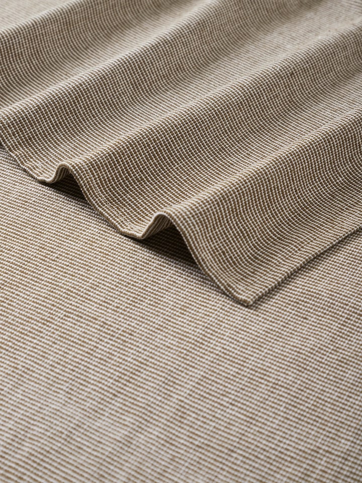 Detailed view of Shikara green chambray cotton bath towel (L) focusing on the fabric texture and color