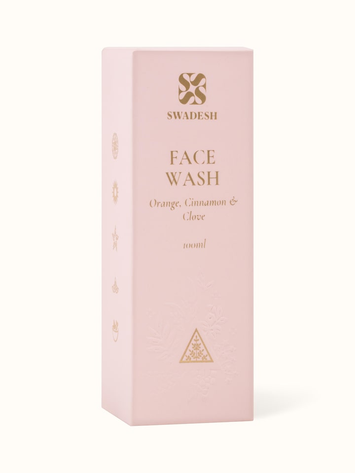 Detail shot of Face Wash Orange, Cinnamon & Clove bottle label and texture of product