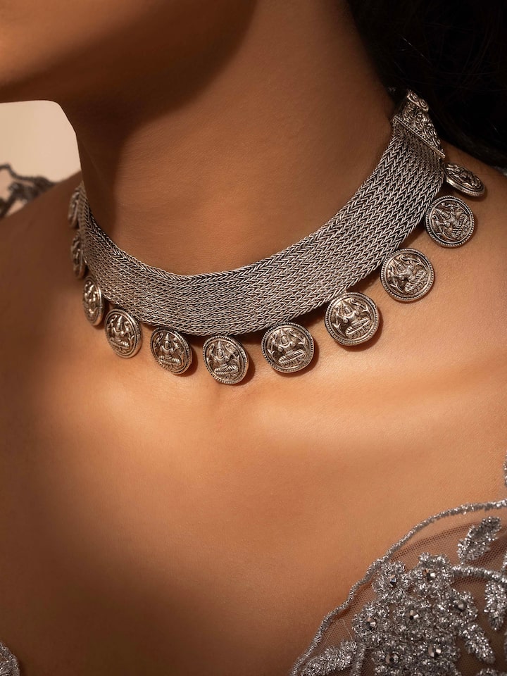 Close-up of Silver collar necklace showing detailed craftsmanship and sleek design elements