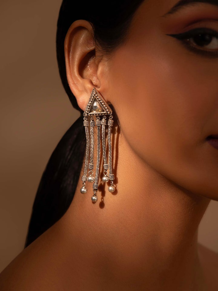 Side view of Silver Drop Earrings highlighting their sleek design and silver finish.