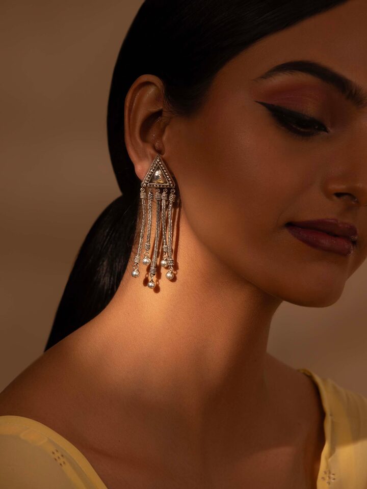 Close-up view of Silver Drop Earrings emphasizing fine silver craftsmanship and detail.