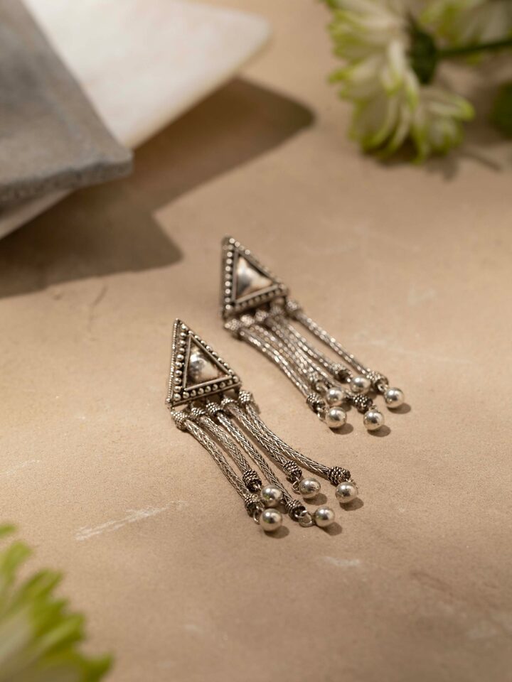 Detailed view of Silver Drop Earrings from a distance highlighting their full design.