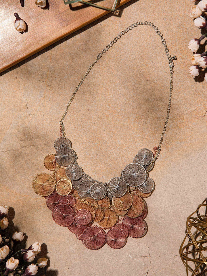 Close-up side view showing beadwork and string details of necklace