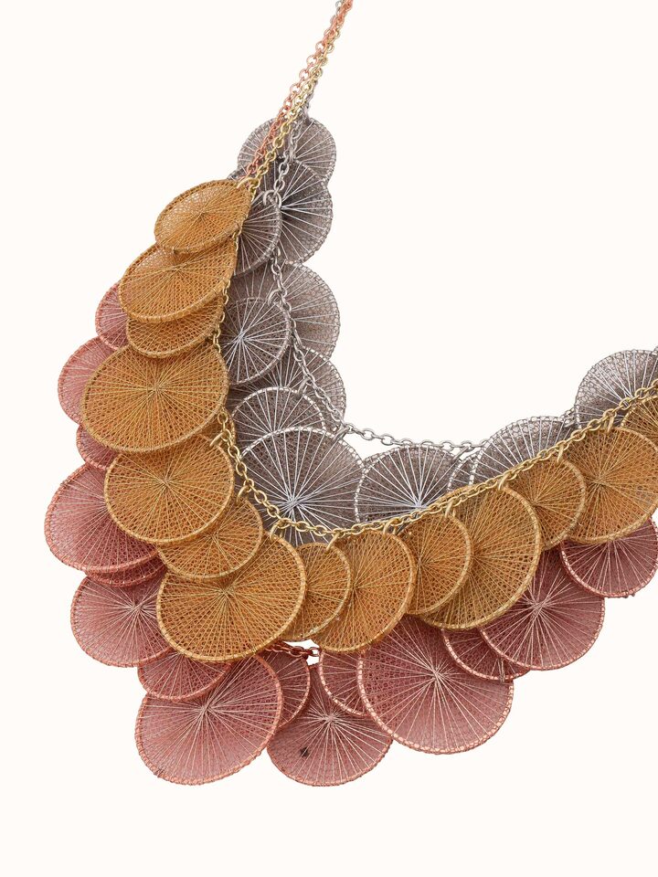 Overhead shot highlighting intricate string craft and bead arrangement