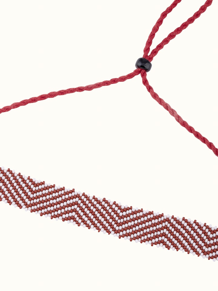 Side view of handcrafted long necklace emphasizing its elegant design and detailed craftsmanship.