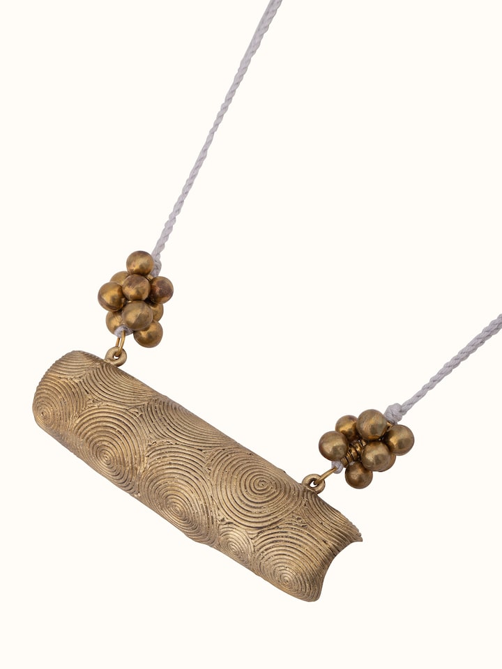 Angled view of Dhokra long necklace showing the artistic pendant design.