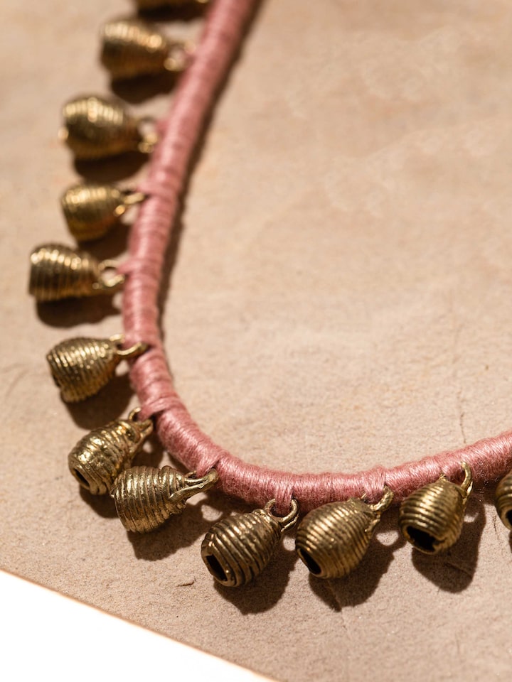 Detailed view of Dhokra long necklace showcasing its fine artisan metalwork and traditional design.
