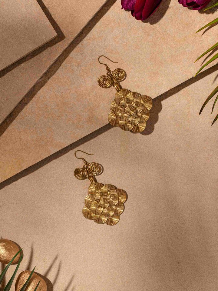 Close-up view of Dhokra Drop Earrings showcasing intricate patterns and handcrafted details.