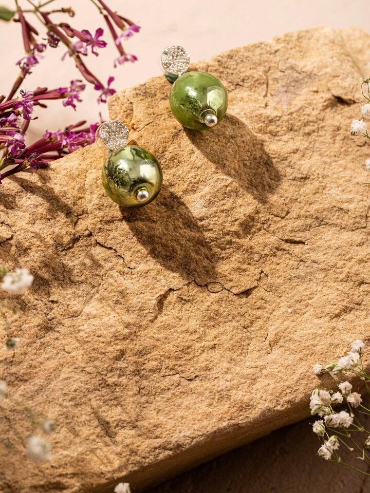 Styled detail view of Silver Flame Glass Drop Earrings worn on the ear, shown in an alternate styled shot
