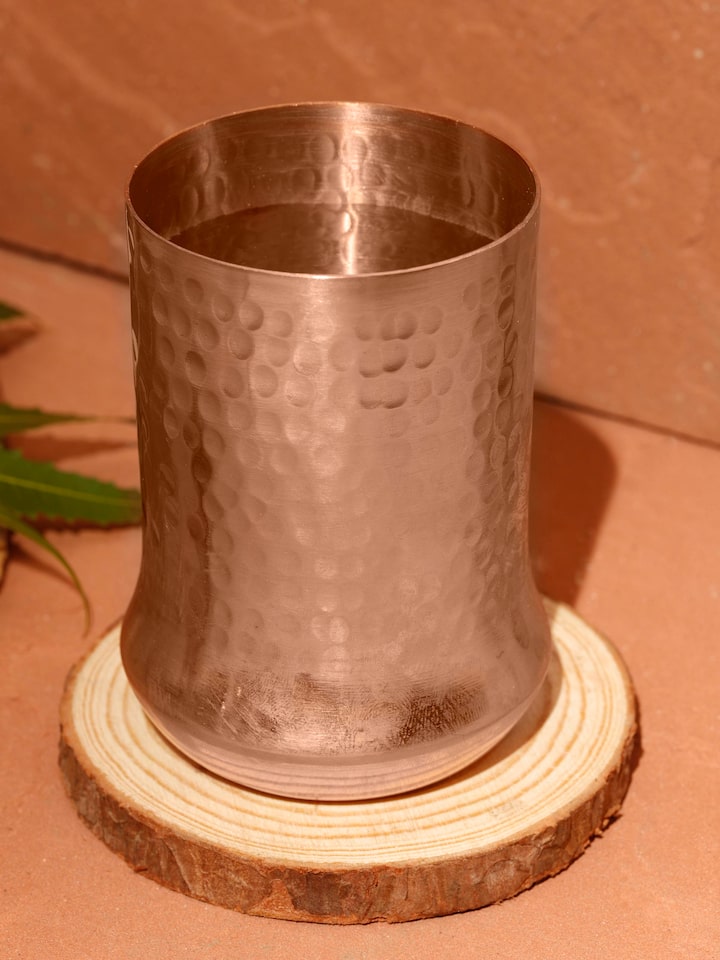 Close-up of intricate detailing on copper metal glass, highlighting its craftsmanship and texture.