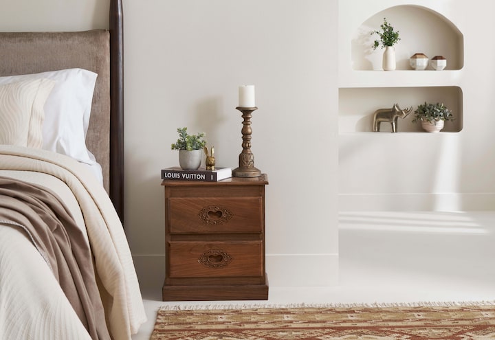Side view of the carved walnut wood bedside table, showcasing the elegant design and craftsmanship