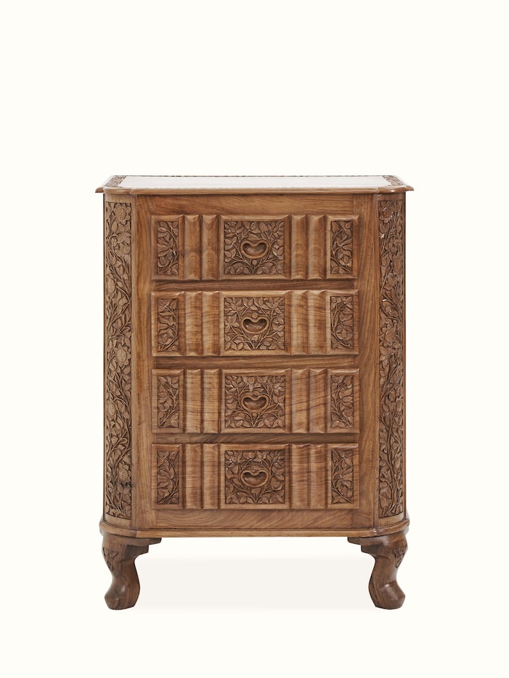 Front view of carved walnut drawer chest, showcasing intricate carving details