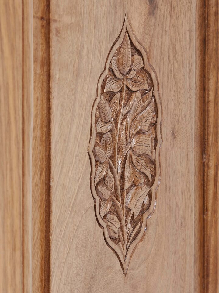 Close-up view of carved walnut drawer chest, showcasing detailed carving patterns