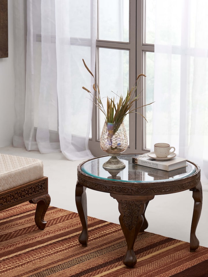 Styled view of Carved Walnut Wood Round Coffee Table with Glass Top styled in a room setting
