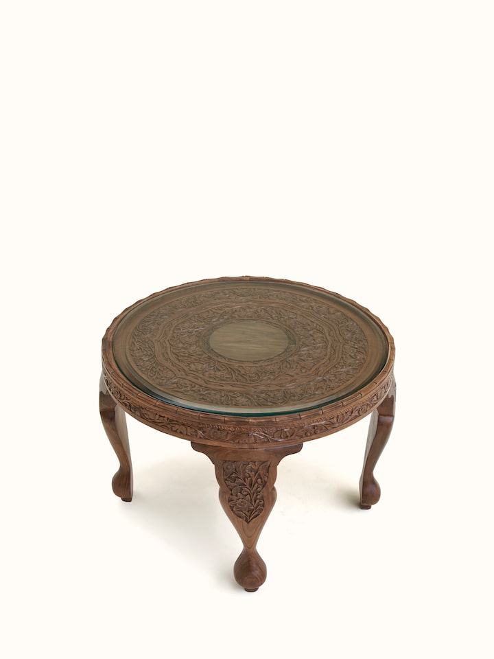 Close-up view of Carved Walnut Wood Round Coffee Table with Glass Top highlighting the inlay work and craftsmanship detail, from a different angle