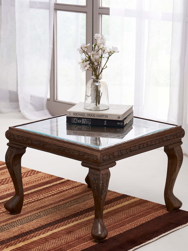 Styled view of Carved Walnut Wood Square Coffee Table with Glass Top styled in a room setting