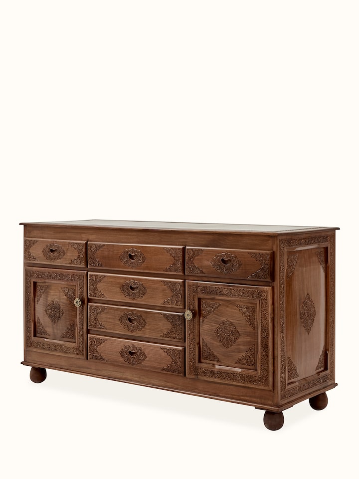 Close-up of the walnut wood sideboard's carvings and drawer handles, emphasizing the craftsmanship and quality of the natural finish.