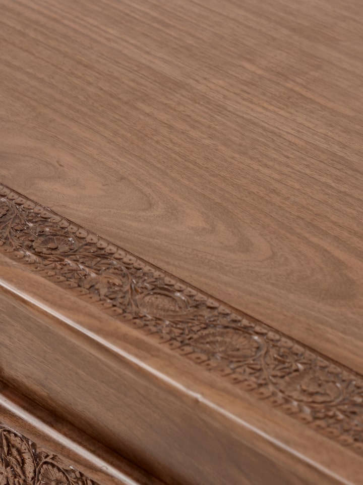 Detailed view of the sideboard’s natural wood finish and drawer fronts, highlighting the rich texture and carved details.