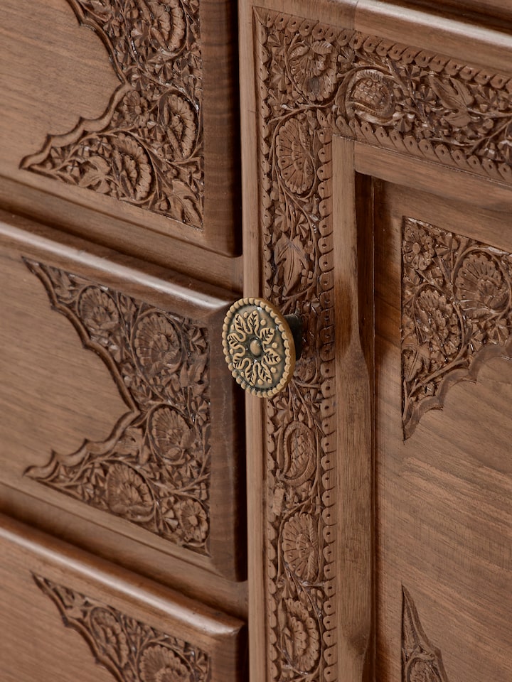 Top view of the walnut sideboard, focusing on the smooth surface and detailed carvings on the edges of the five drawers.