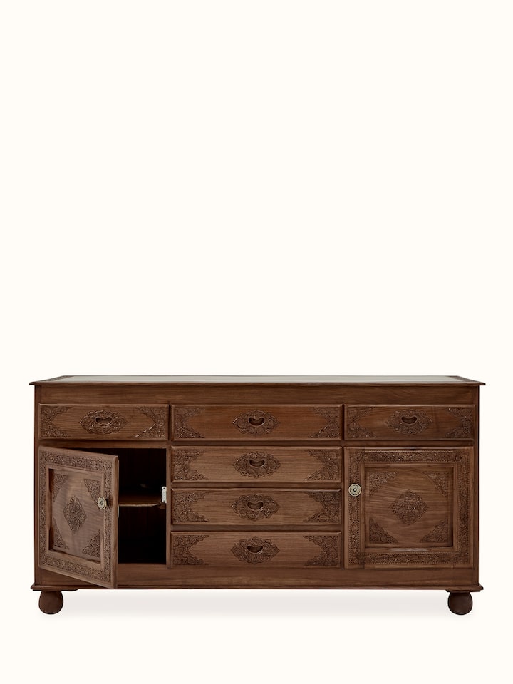 Close-up of the walnut sideboard's drawer handles and carvings, showcasing the fine details and natural wood texture.
