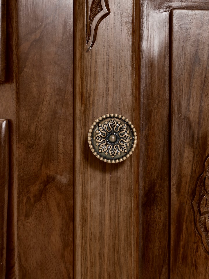 Side angle view of the walnut wood sideboard, highlighting its drawers and natural finish