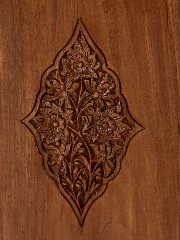 Perspective view of carved walnut wood wardrobe, emphasizing the depth and details of the wood carvings