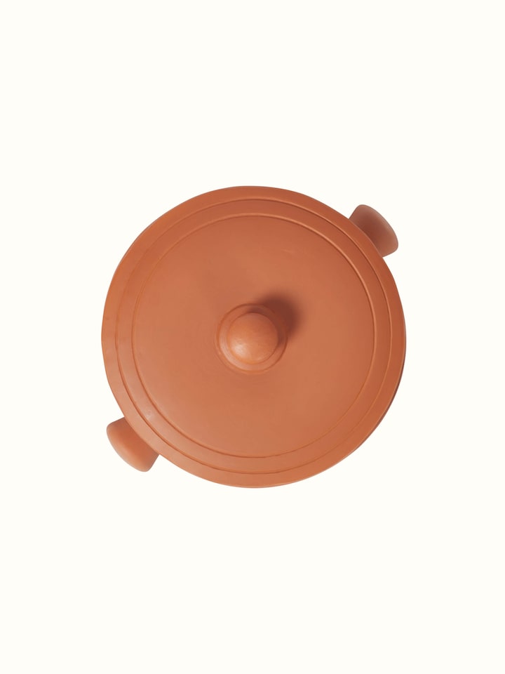 Close-up of terracotta clay cooking pot, emphasizing its artisanal features