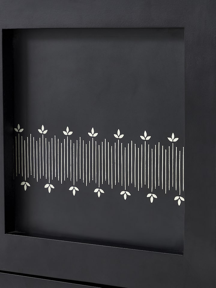 Detailed view of the metal and Bidriware inlay on the mango wood bookshelf