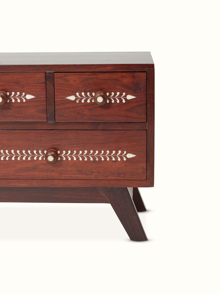 Detailed view of the bone inlay pattern on the Sheesham wood entertainment unit, showing its fine artistic details.